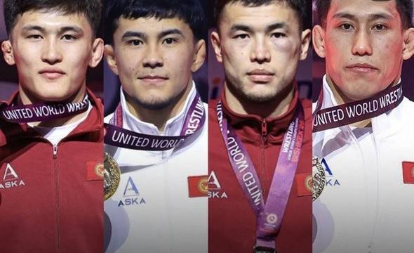 Four wrestling medalists in the red ceremony jackets