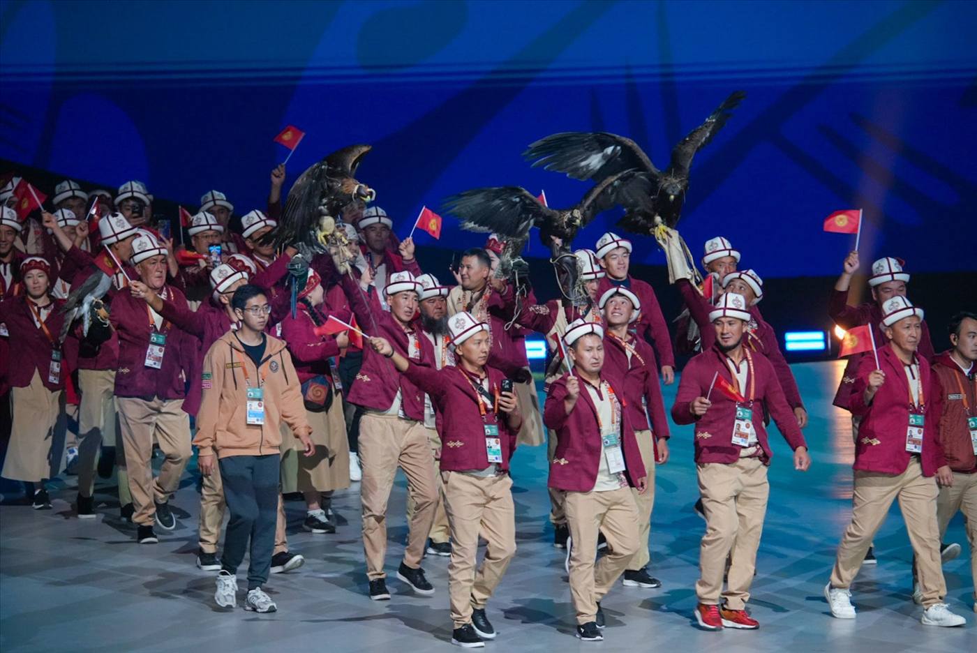 Team Kyrgyzstan with golden eagles at the Astana 2024 opening ceremony, wearing the parade uniform